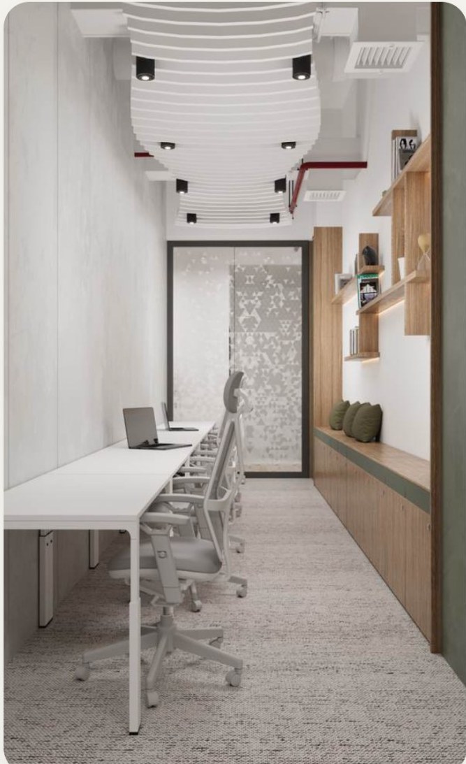 A long hot desk bench beside a shelved wall.